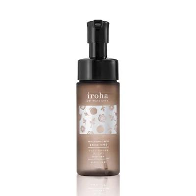 A brown translucent bottle with a black pump top, labelled iroha INTIMATE CARE with a floral pattern